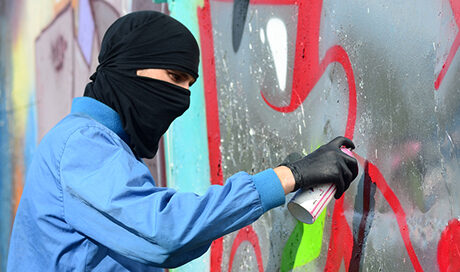 Storefront vandalized with graffiti showing need for protective anti-graffiti window film