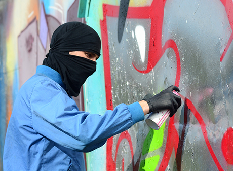 Storefront vandalized with graffiti showing need for protective anti-graffiti window film